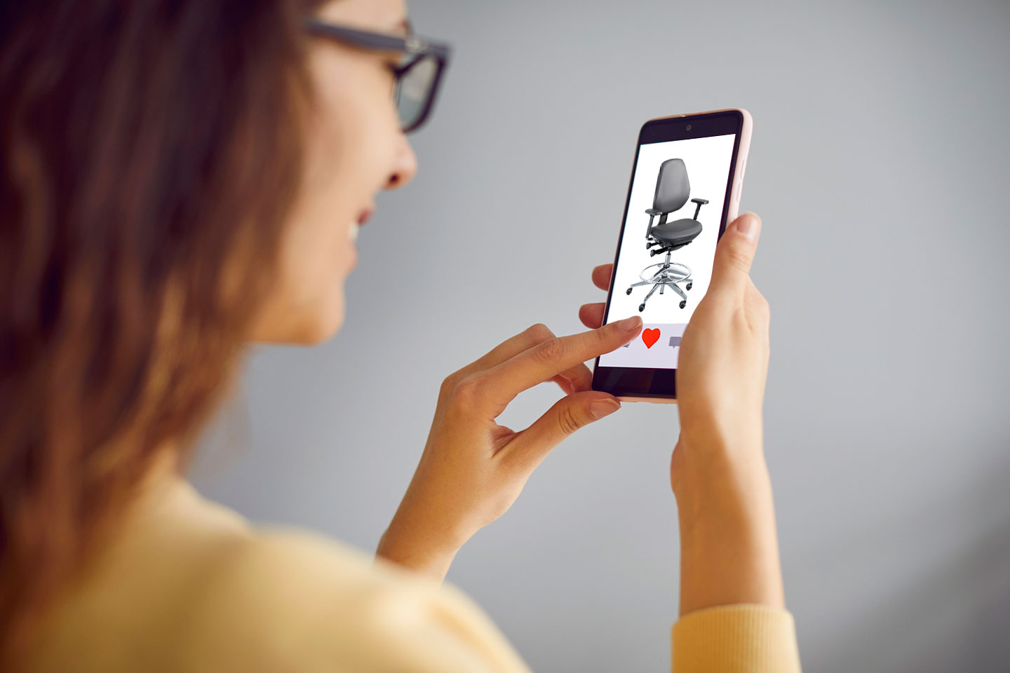 Woman choosing heart to select BioFit MVMT chair in dating app